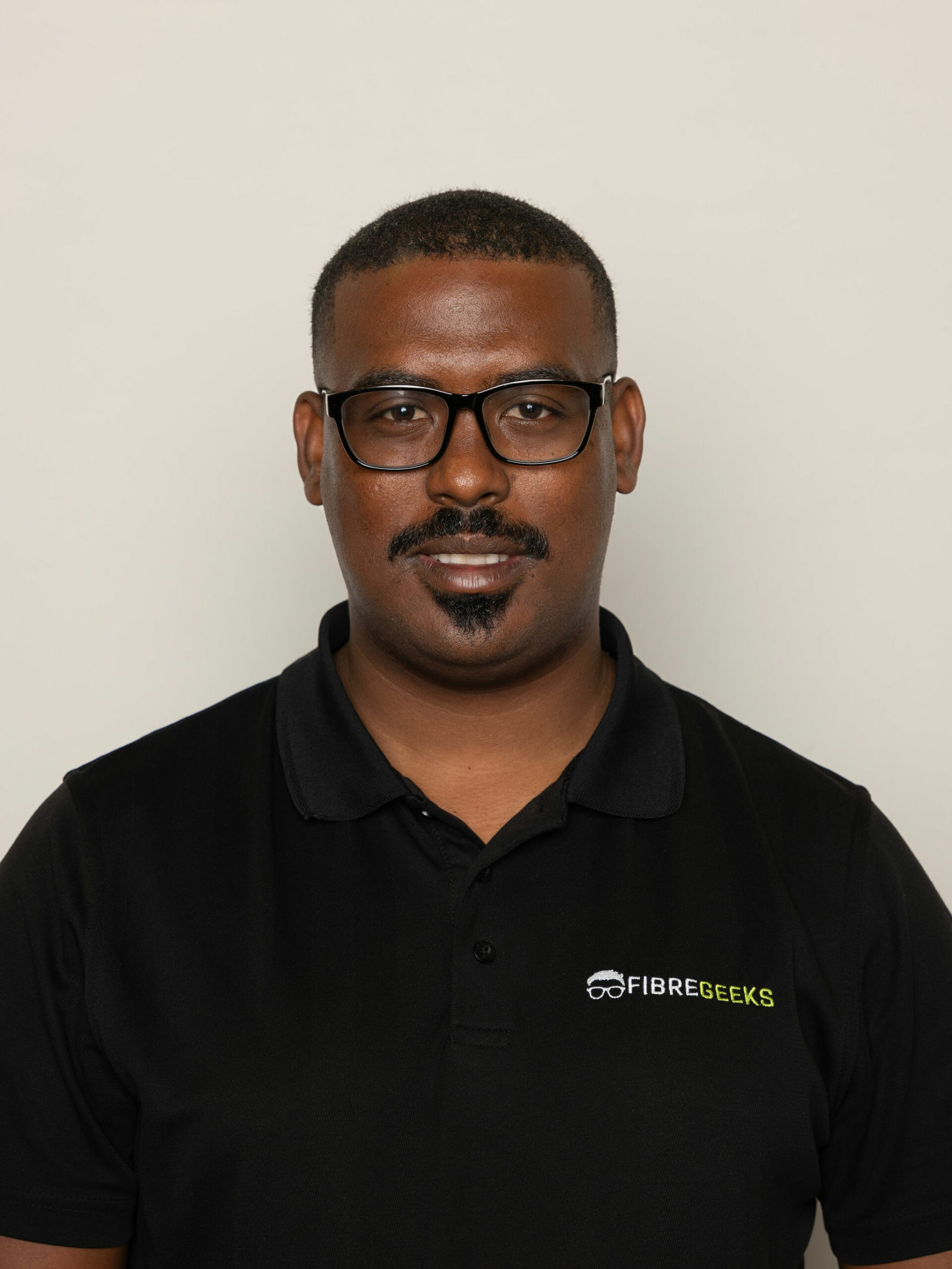 a man wearing glasses and a black shirt